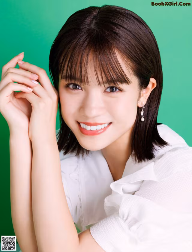 A woman in a white shirt posing for a picture.