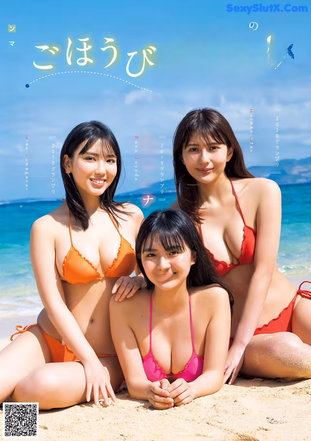 A group of three women in bikinis sitting on a beach.