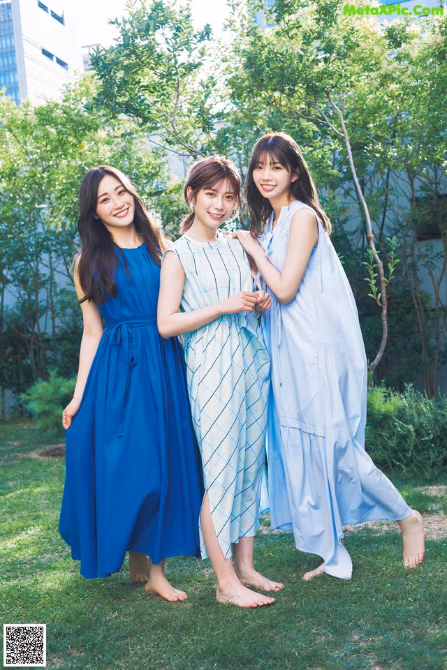 A group of three young women standing next to each other.