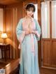 A woman in a blue and pink kimono posing for the camera.