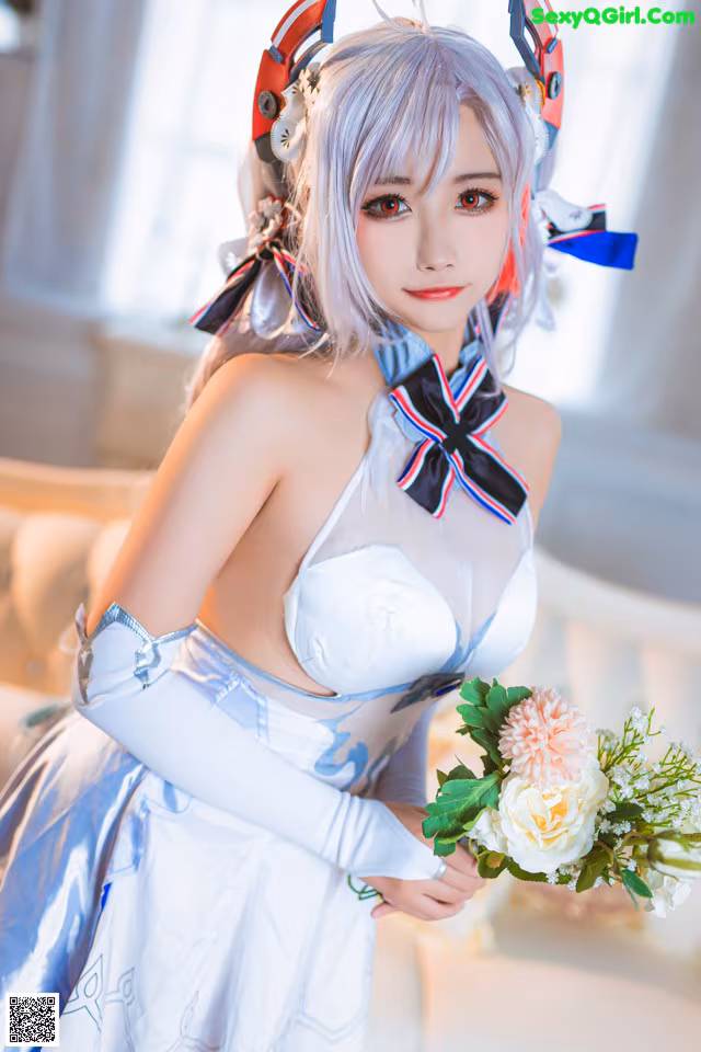 A woman in a white dress holding a bouquet of flowers.