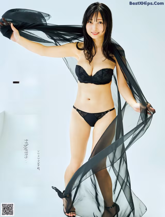 A woman in a black lingerie posing for a magazine.