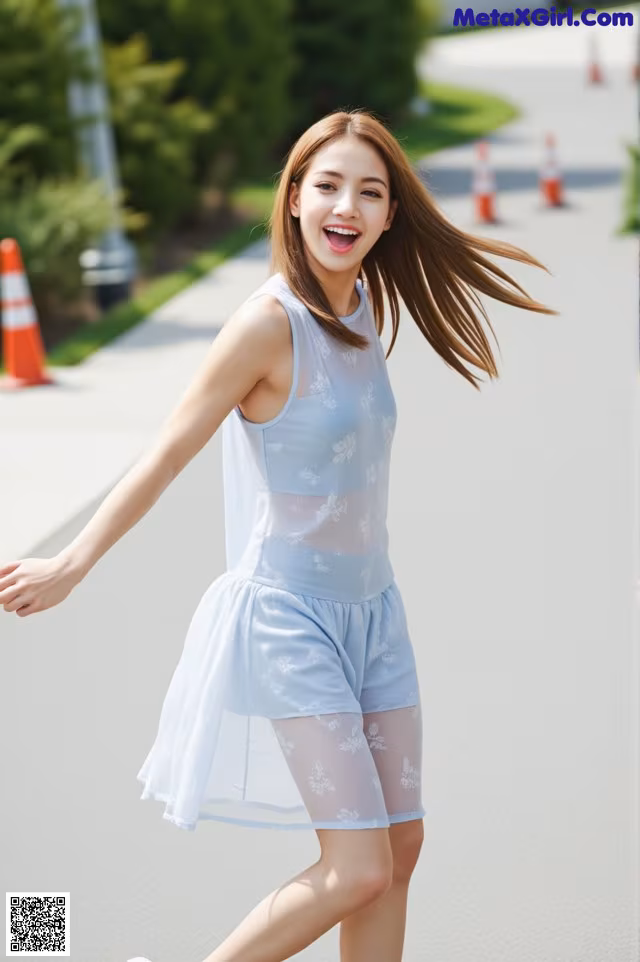 A young woman in a blue dress is walking down the street.